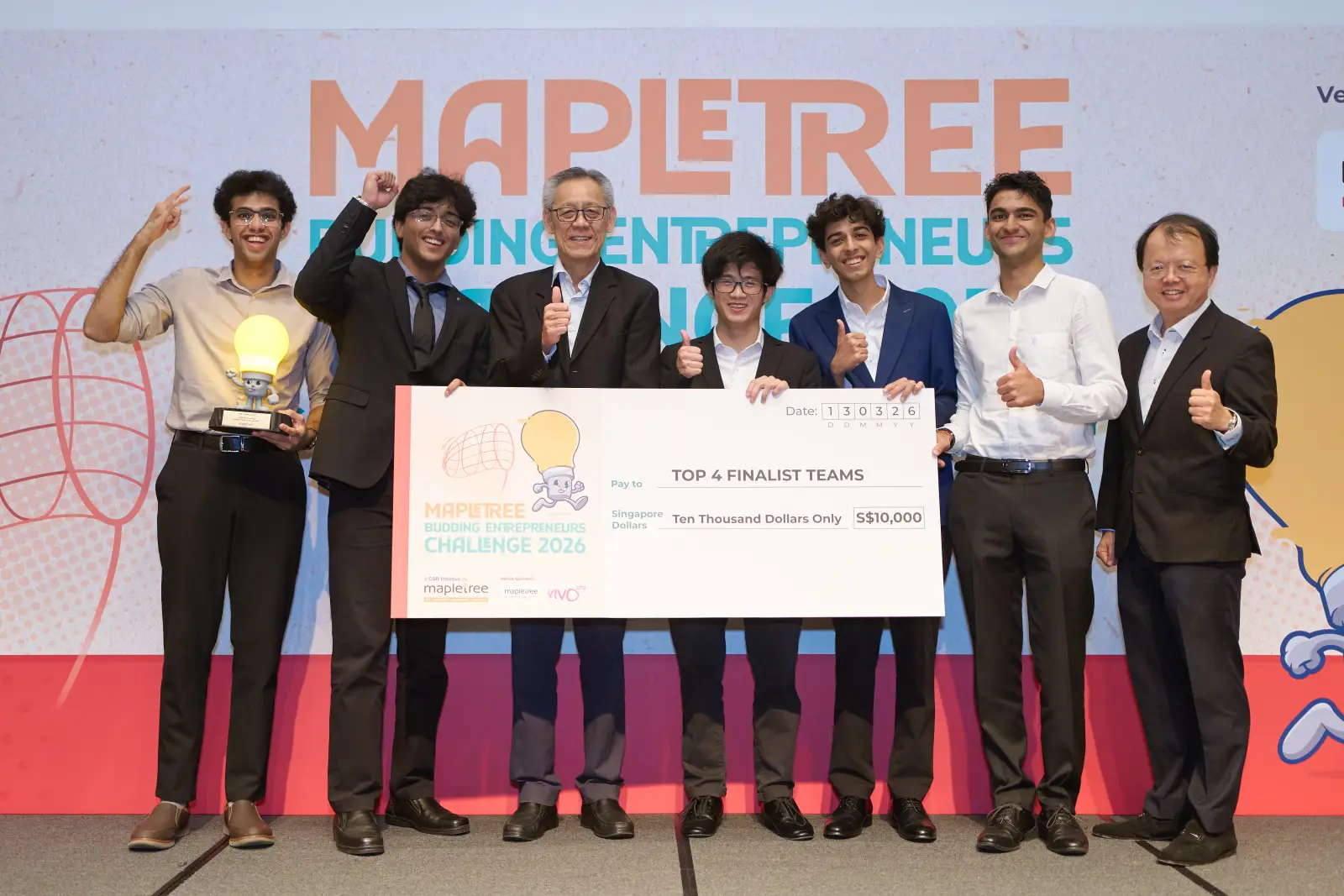 The PhysiCode team on stage at the Mapletree Budding Entrepreneurs Challenge finals, holding an oversized S$10,000 cheque